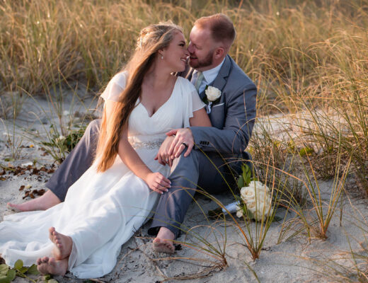 When to apply for your marriage license. Photo showing bride and groom sitting on beach