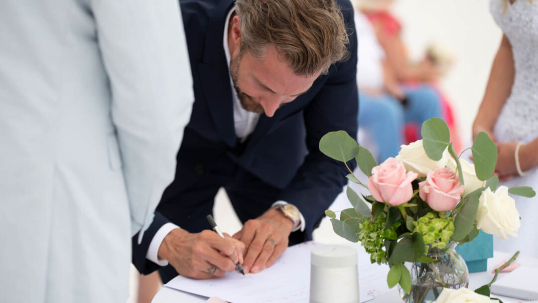Convenient marriage license by mail. Photo of person signing the Florida marriage license by mail.